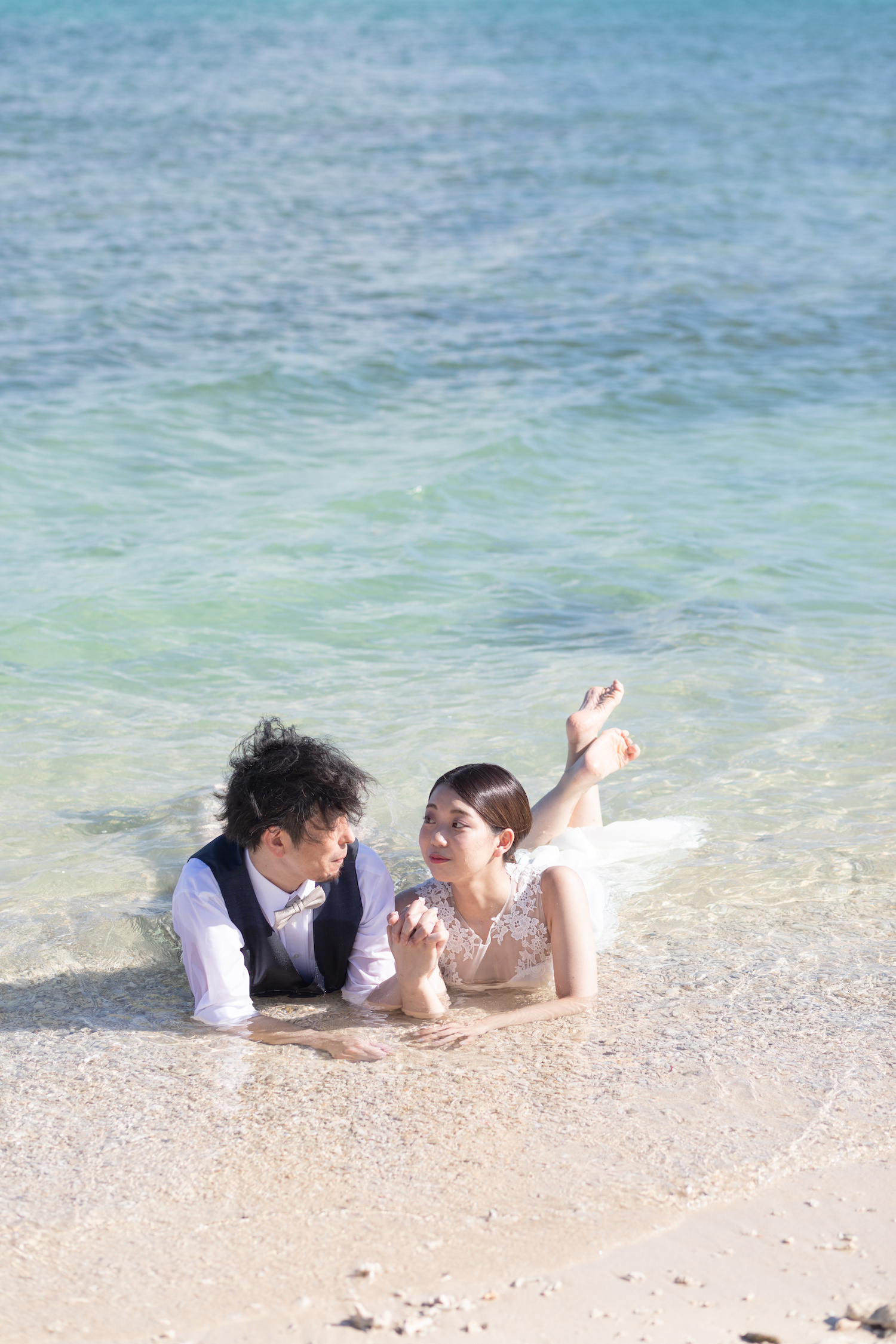 海に入って寝転ぶ新郎新婦